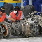 In this Nov. 4, 2018 photo, officials inspect an engine recovered the crashed Lion Air jet in Jakarta, Indonesia. (AP Photo/Achmad Ibrahim, File)