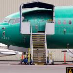 In this April 8 photo, a Boeing 737 MAX 7 jet is parked near single engine planes at the airport adjacent to a Boeing Co. production facility in Renton. (AP Photo/Elaine Thompson, File)
