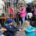 South Whidbey Elementary School students Weston Dill (right) and Taylor Jones (left) pull ropes aboard the Lady Washington historic tall ship in Langley harbor on Thursday. (Wendy Leigh / South Whidbey Record)