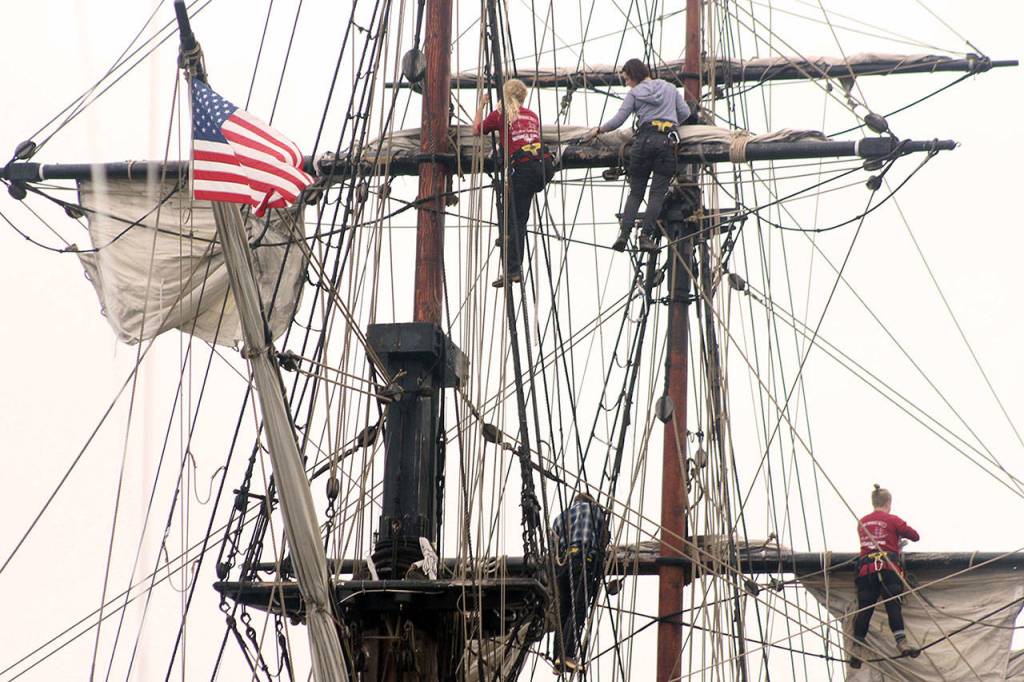 Deckhands prepare the sails on Lady Washington historic tall ship in Langleys harbor. (Wendy Leigh / South Whidbey Record)
