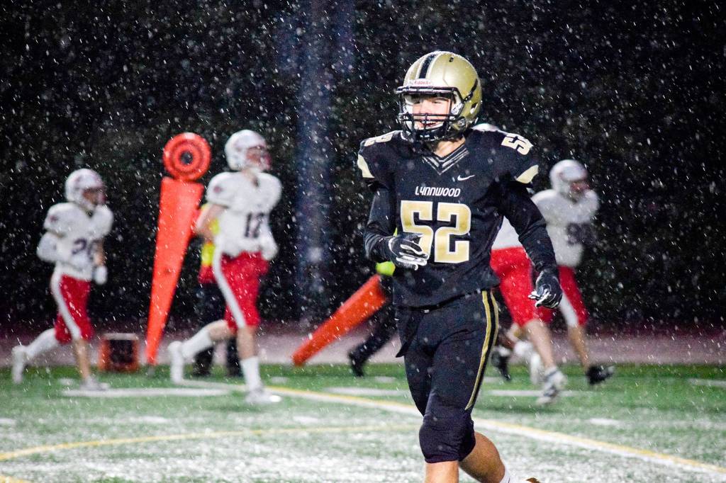 Lynnwood sophomore defensive lineman Kadin Carroll smiles towards the sidelines after making a defensive stop against Juanita on Friday, Sept. 27 at Edmonds Stadium. (Katie Webber / The Herald)