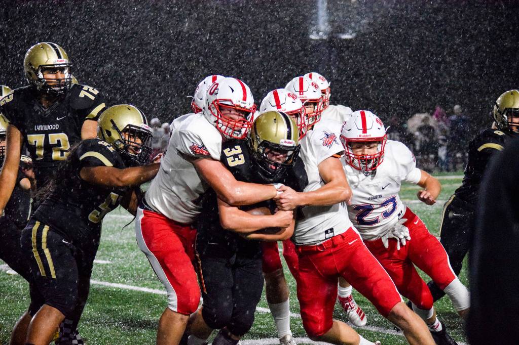 Lynnwood sophomore tight end Zach Newson gets pushed towards the sidelines by the Juanita defense on Friday, Sept. 27 at Edmonds Stadium. (Katie Webber / The Herald)