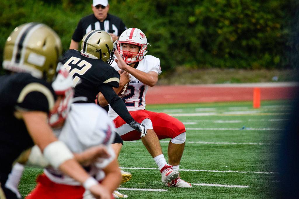 Juanita senior running back Brayden Brown runs into the Lynnwood defense on Friday, Sept. 27 at Edmonds Stadium. (Katie Webber / The Herald)