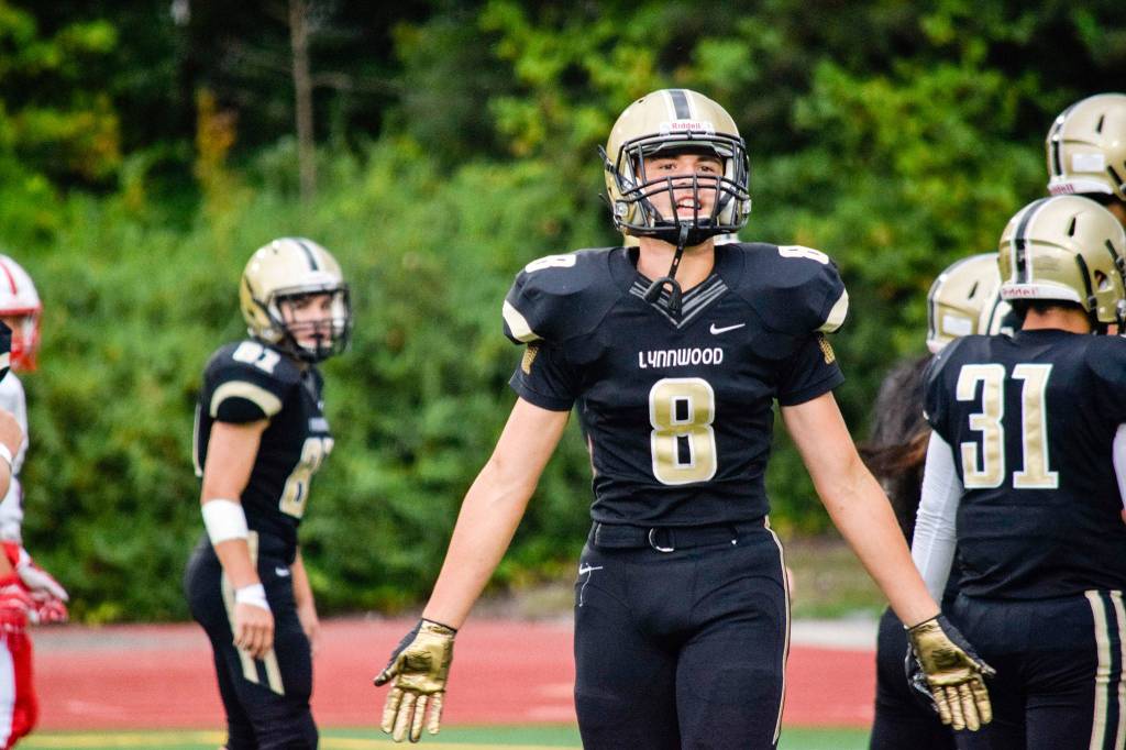 Lynnwood junior wide receiver Tanner Fahey interacts with the Lynnwood fans against Juanita on Friday, Sept. 27 at Edmonds Stadium. (Katie Webber / The Herald)