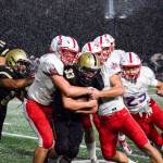 Lynnwood sophomore tight end Zach Newson gets pushed towards the sidelines by the Juanita defense on Friday, Sept. 27 at Edmonds Stadium. (Katie Webber / The Herald)
