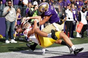 Washington defensive back Myles Bryant (right) breaks up a pass in the end zone during the fourth quarter of the Huskies 28-14 win over USC on Saturday at Husky Stadium. (Elaine Thompson / Associated Press)