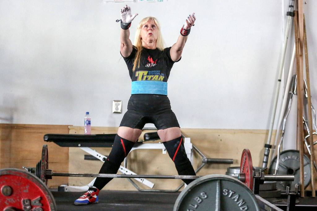 Cindy Goodrich prepares to deadlift during a training session at EGO Strength and Performance on Sept. 24 in Everett. (Kevin Clark / The Herald)