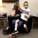 Saban Baum, 6, sits with his mom, Misty, after he ate 12 peanuts as part of oral immunotherapy treatment, in which patients with food allergies are actually given small (though increasing) amounts of the food that causes the allergies. The Baums were waiting at Premier Allergy & Asthma to see if he had a reaction to the peanuts. There was none. (Chicago Tribune)