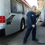 Craig Jacobsen, a technician at Everett Transit, demonstrates the charging process for the new electric buses. The new system takes about four hours to charge the batteries. (Lizz Giordano / The Herald)