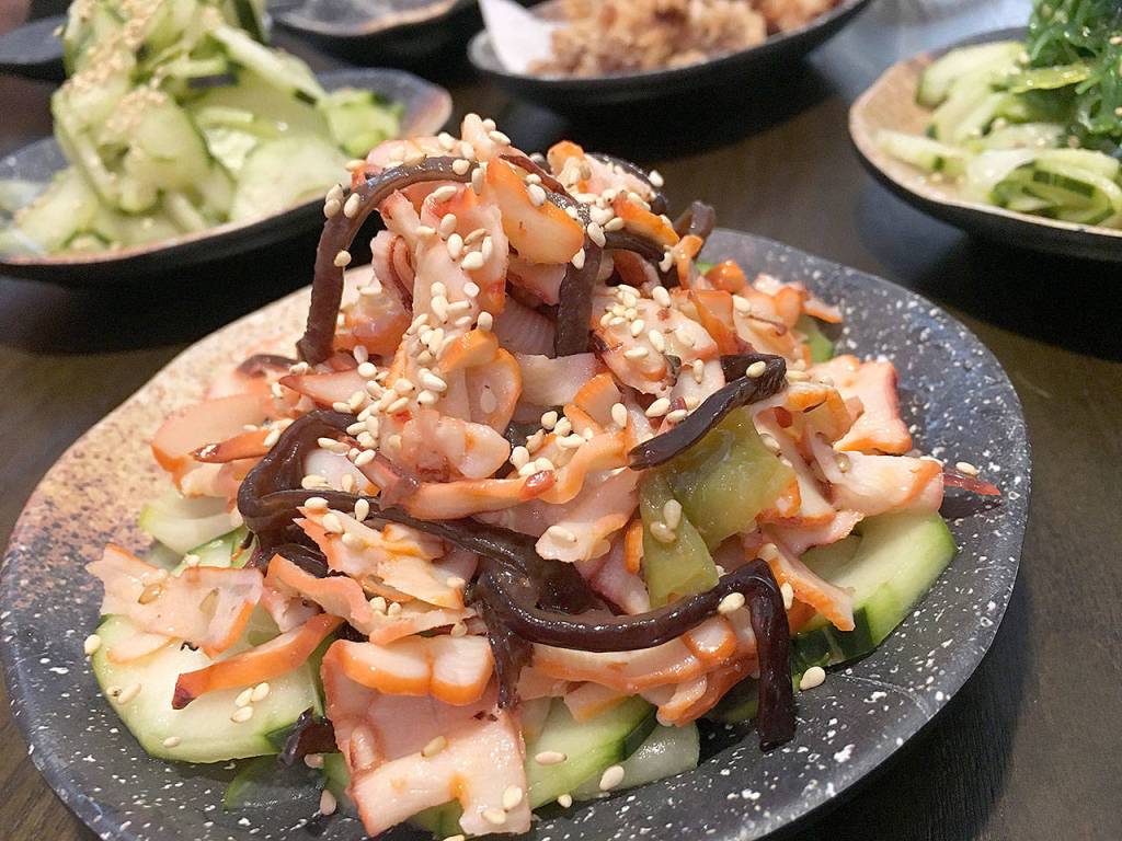 The squid salad is composed of chopped squid atop a bed of sweet and sour cucumber slices at Botan Ramen n Bar in Everett. (Ben Watanabe / The Herald)
