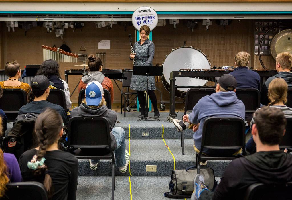 Tracey Paddock, a clarinet player for the U.S. Marine Band, speaks to an Everett High School band class before playing a piece on Friday. (Olivia Vanni / The Herald)