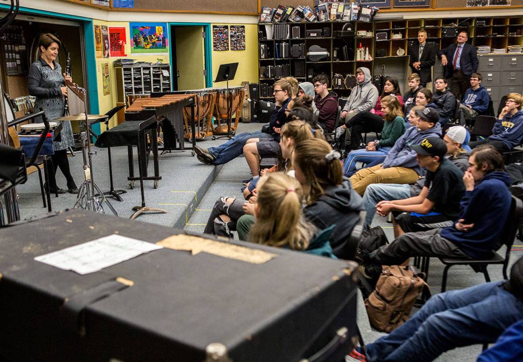 Everett High School band students listen while members of the U.S. Marine Band speak and perform for their class on Friday morning. (Olivia Vanni / The Herald)