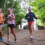 Alexis Palmer (left) and Lindsay Arday shares a laugh during warm-ups before running Wednesday afternoon at Lord Hill Regional Park in Snohomish on October 2, 2019. (Kevin Clark / The Herald)