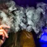 A woman exhales while using a cannabis vape pen in Los Angeles in December 2018. Health officials are urging consumers to stop vaping of any kind until investigators determine why hundreds of people nationwide have been sickened after using the devices. (Richard Vogel / Associated Press file photo)