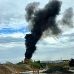Smoke fills the sky after a World War II-era bomber plane crashed Wednesday outside Bradley International Airport north of Hartford, Connecticut. A spokesman for Gov. Ned Lamont confirmed the crash of the B-17 plane. (Antonio Arreguin via AP)