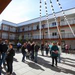 Hundreds of people wander around apartments and the courtyard at HopeWorks Station on Friday. (Andy Bronson / The Herald)