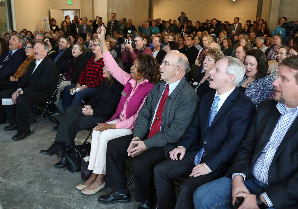 Lynnwood City Council member Shirley Sutton cheers along with hundreds of people gathered at HopeWorks Station for an opening ceremony Friday. (Andy Bronson / The Herald)
