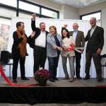 Local leaders cheer after a ribbon is cut at HopeWorks Station on Friday in Everett. The building will have 65 units for families, veterans and young adults. (Andy Bronson / The Herald)