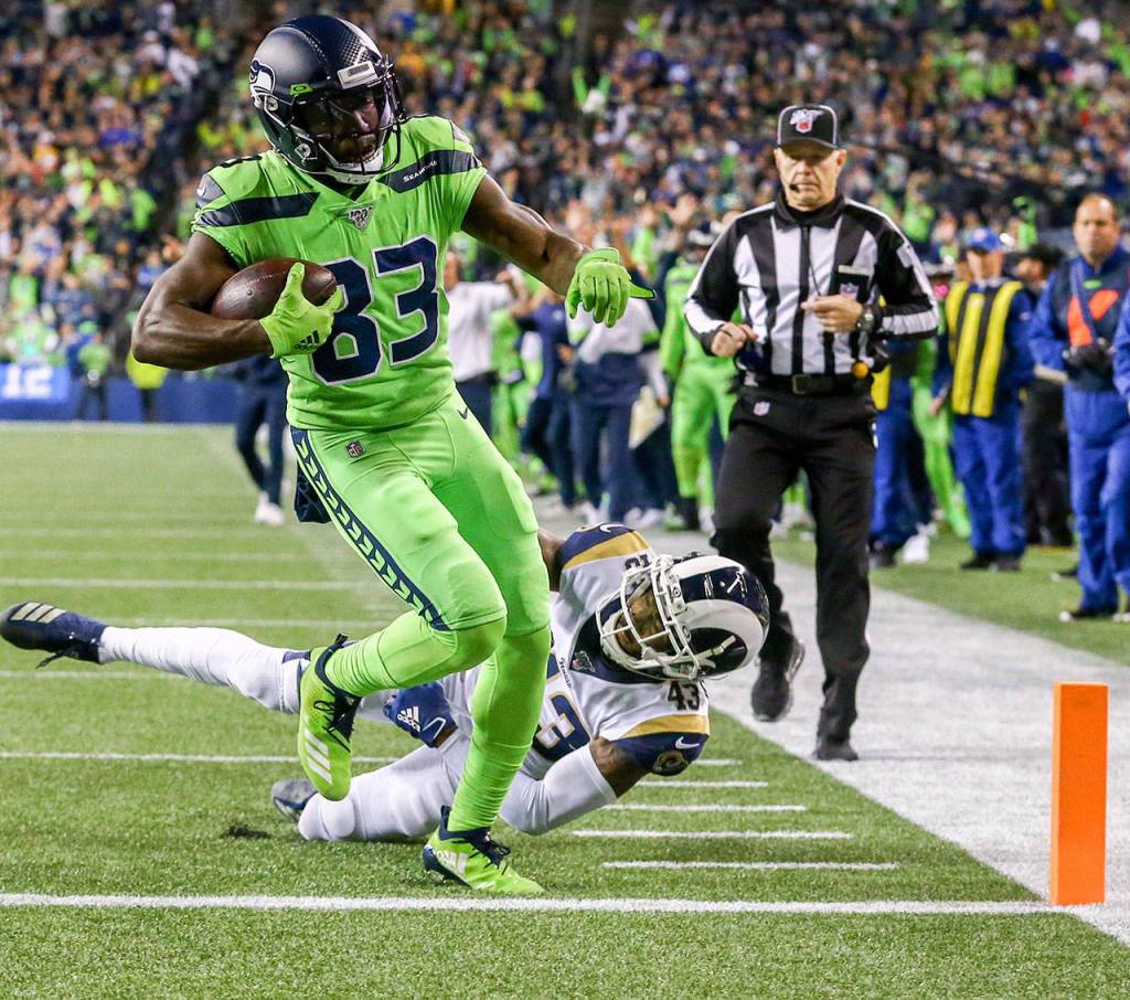 Seattles David Moore (83) scores on a 10-yard touchdown pass as the L.A. Rams John Johnson dives to stop him in the third quarter of the Seahawks 30-29 win Thursday at CenturyLink Field in Seattle. (Kevin Clark / The Herald)