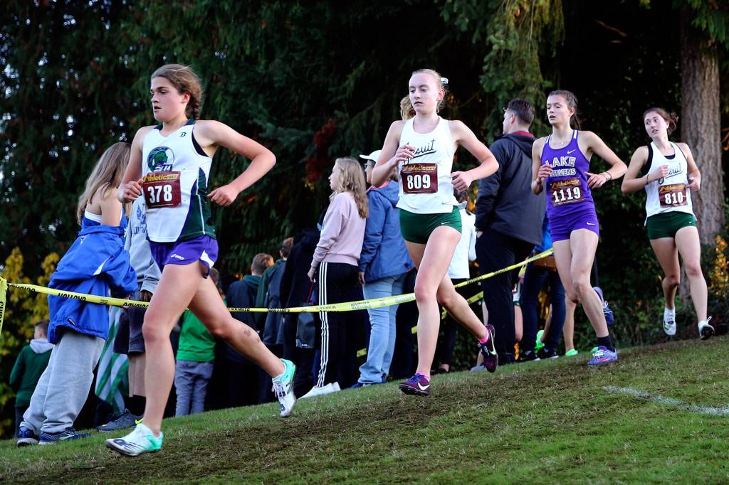 Runners make their way through the course Saturday evening during the 13th Annual Twilight XC Invitational at Cedarcrest Golf Course in Marysville on October 5, 2019. (Kevin Clark / The Herald)