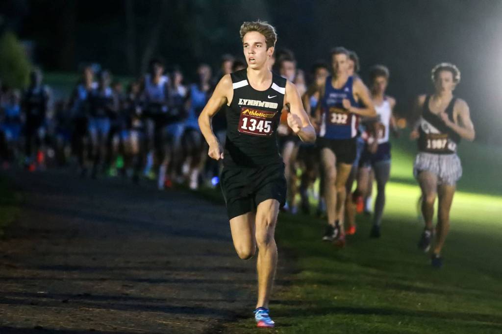 Runners make their way through the course Saturday evening during the 13th Annual Twilight XC Invitational at Cedarcrest Golf Course in Marysville on October 5, 2019. (Kevin Clark / The Herald)