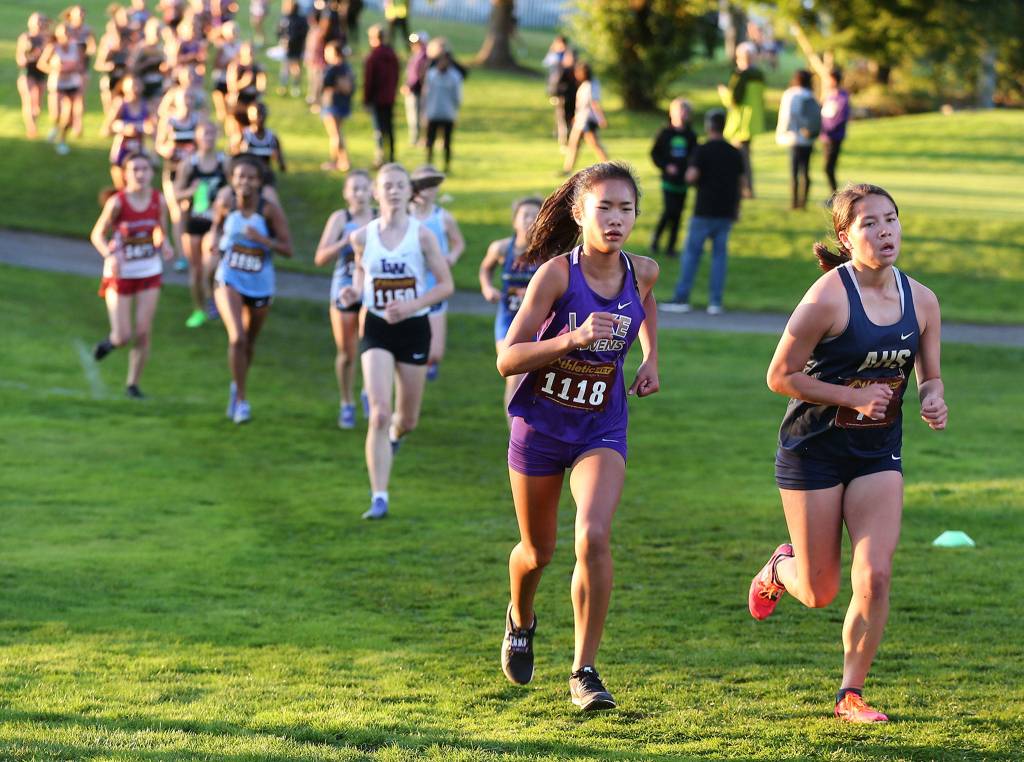 Runners make their way through the course Saturday evening during the 13th Annual Twilight XC Invitational at Cedarcrest Golf Course in Marysville on October 5, 2019. (Kevin Clark / The Herald)