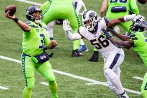 Seattle Seahawks quarterback Russell Wilson (3) throws under pressure from Los Angeles Rams defensive end Dante Fowler (56) in the first quarter at CenturyLink Field in Seattle on Thursday, Oct. 3, 2019. (Andy Bao/Seattle Times/TNS)