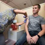 Rocky Oliphant gets a flu shot at the Everett Clinic in October 2018 in Everett. (Andy Bronson / Herald file photo)