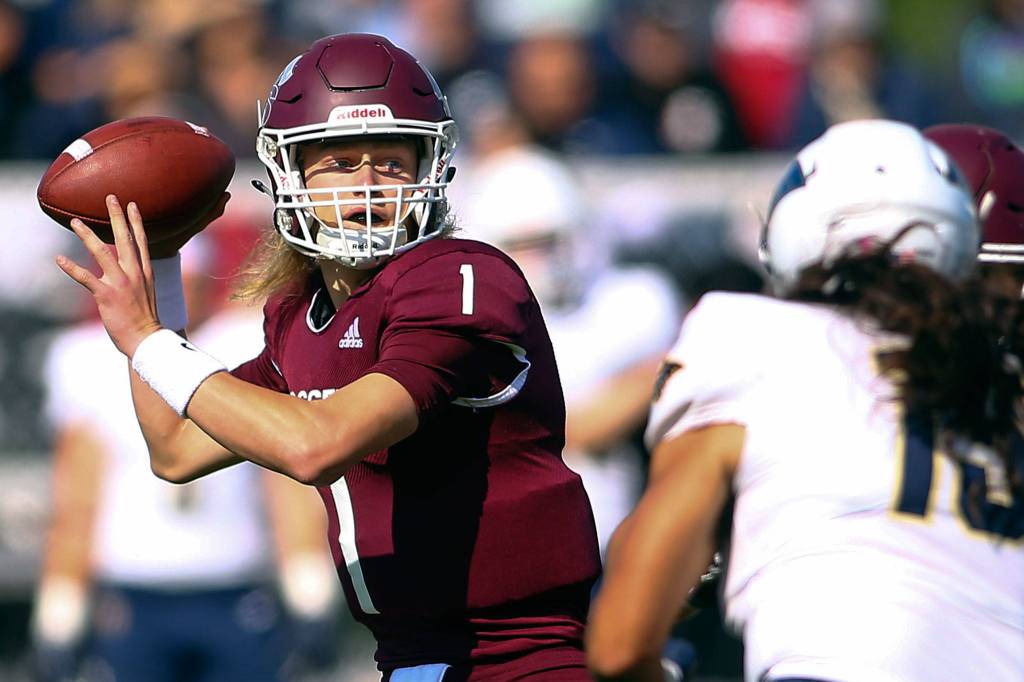 Murdock Rutledge, Everett High alumni and University of Puget Sound junior quarterback, looks down field to pass against George Fox Saturday afternoon in Tacoma on Oct. 5, 2019. (Kevin Clark / The Herald)