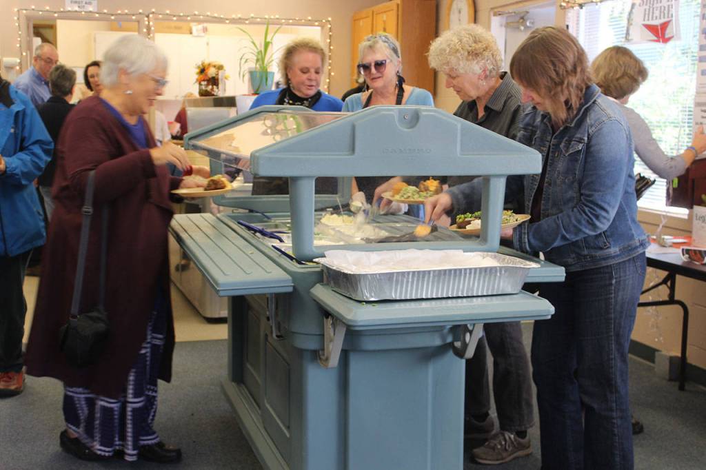 Community members gather for a meal at Leos Place in Bayview on Whidbey Island, which opened on Oct. 1. (Wendy Leigh / South Whidbey Record)
