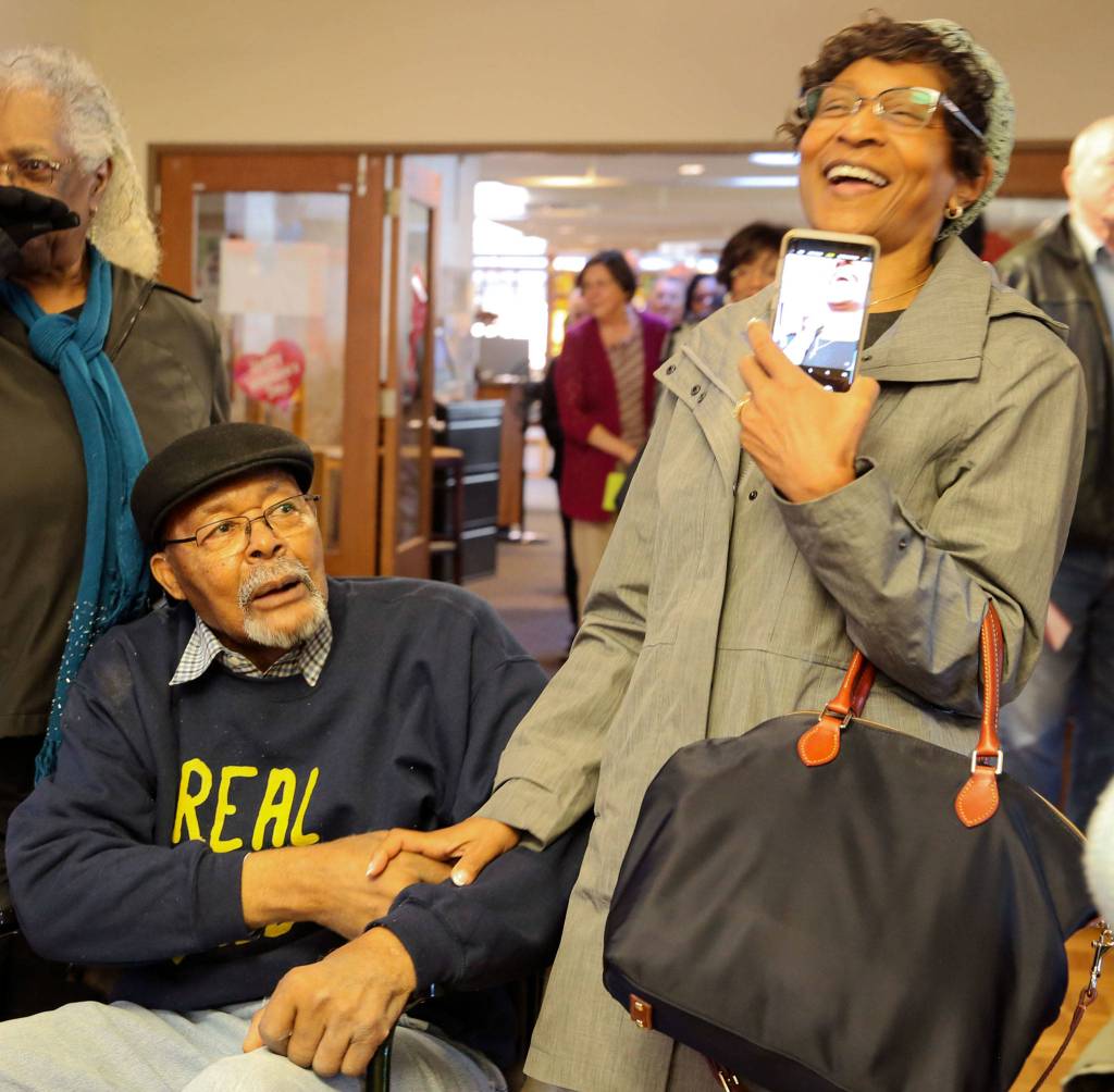 Carl Gipson laughs with Nyetta Patton during his birthday party Jan. 12 at the Carl Gipson Senior Center in Everett. (Kevin Clark / The Herald)