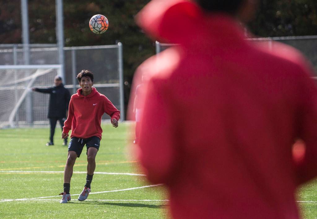 Everett Community Colleges Efren Martinez receives a pass from a teammate during the Trojans Oct. 8 practice at Kasch Park in Everett. (Olivia Vanni / The Herald)
