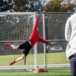 Everett Community College mens soccer goalkeeper Cameron Beardsley dives to make a save during the Trojans Oct. 8 practice at Kasch Park in Everett. (Olivia Vanni / The Herald)