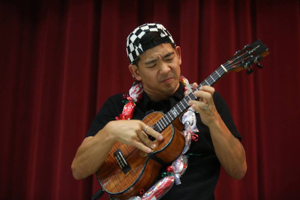 Jake Shimabukuro, a renowned ukulele player, performs Monday at Frank Wagner Elementary in Monroe. The school started a ukulele program last year and recently got grant money for new instruments. (Andy Bronson / The Herald)