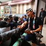 Jake Shimabukuro high-fives students and sign ukuleles after performing at Frank Wagner Elementary. (Andy Bronson / The Herald)