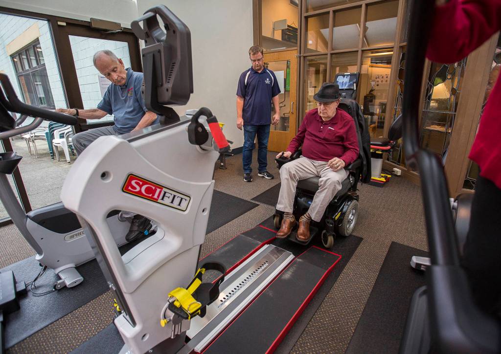 Ron Moran tests out the wheelchair accessible SCIFIT machine at the Carl Gipson Senior Centers new fitness room. (Olivia Vanni / The Herald)