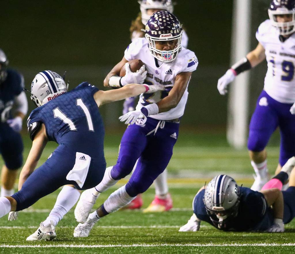Lake Stevens Kasen Kinchen dodges a tackle attempt by Glacier Peaks Jadon Claps Friday night at Veterans Memorial Stadium in Snohomish on October 11, 2019. (Kevin Clark / The Herald)