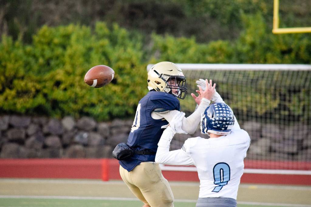 Junior defensive back Samuel Lybee (right) breaks up a catch from junior wide receiver Cody Bennett (left) on Friday, Oct. 11 at Everett Memorial Stadium. (Katie Webber / The Herald)