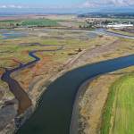 Before the breach of levees and dikes on Monday along Leque Island (left), the Stillaguamish River winds past Stanwood (upper right). (Chuck Taylor / The Herald)