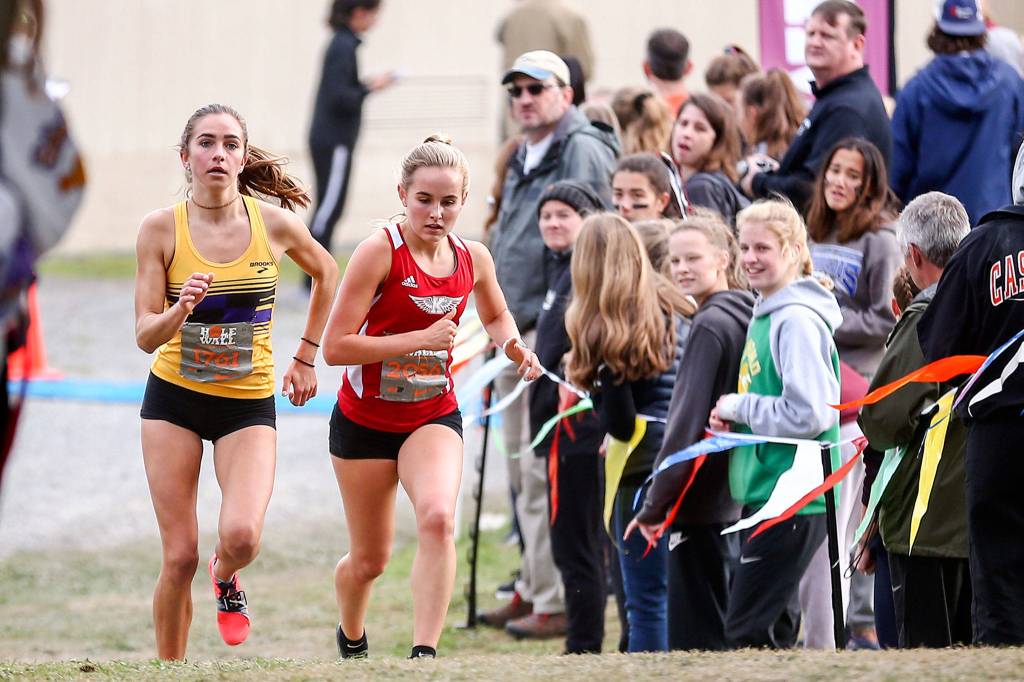 Kings senior Naomi Smith (right) and Issaquah junior Julia David-Smith own the top two girls times in the entire state this season. (Kevin Clark / The Herald)