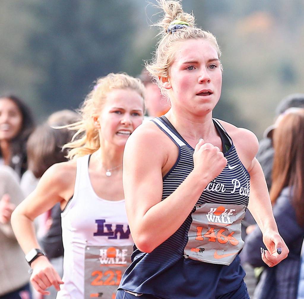 Glacier Peak senior Alexis Palmer (right) races Saturday afternoon during the 36th annual Hole in the Wall Invitational at Lakewood High School. (Kevin Clark / The Herald)