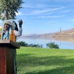 JoDe Goudy, chairman of the Yakama Nation, speaks with the Columbia River in the background near The Dalles, Oregon, on Monday where Celilo Falls, an ancient salmon fishing site, was destroyed by the construction of the Dalles Dam in the 1950s. (AP Photo/Gillian Flaccus)
