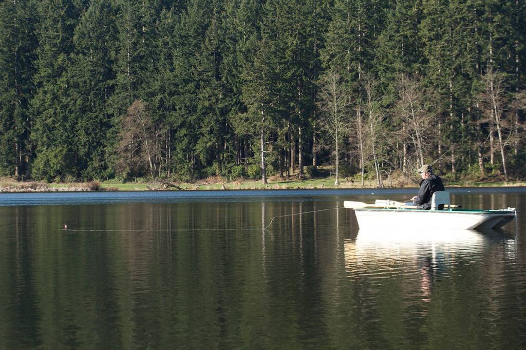 Dale Dennis of Arlington fishes a chironomid pupa pattern on Whidbey Islands Lone Lake. (Mike Benbow photo)