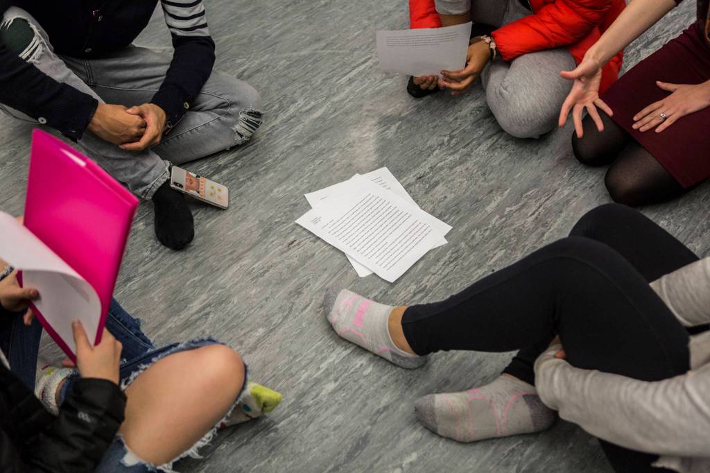 Students gather in a circle to talk about their essays they presented to their groups during class. (Olivia Vanni / The Herald)