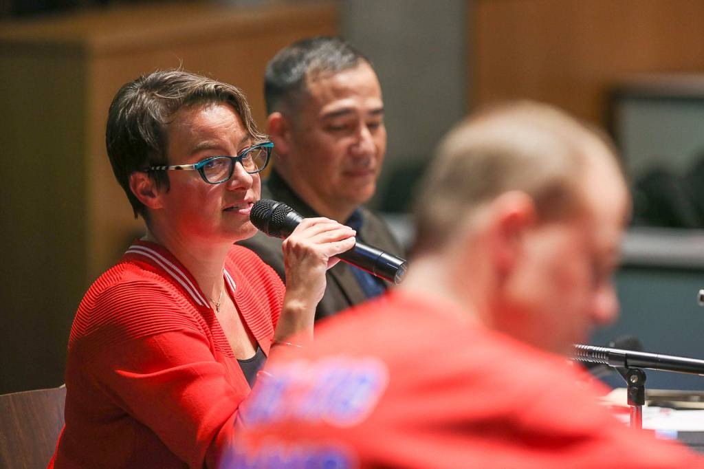 Everett Mayor Cassie Franklin (left) speaks in opposition to Initiative 976 at a Herald forum regarding the ballot measure at Washington State Universitys North Puget Sound campus Thursday in Everett. Steve Hobbs (center), the Democratic chairman of the state Senate Transportation Committee, and initiative proponent Tim Eyman listen. (Andy Bronson / The Herald)