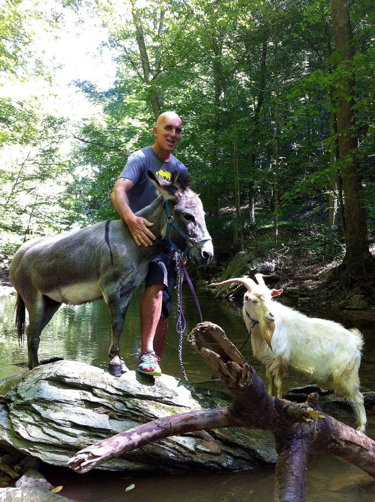 Chris McDougall, Sherman, and farm goat Chili Dog. (Mika McDougall)