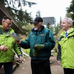 Jim Corcoran (center) passes his property deed to Snohomish County Parks, Recreation and Tourism Department director Tom Teigen (left). (Olivia Vanni / The Herald)