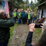 A group of friends, family and Snohomish County officials gather for a group photo at Jim Corcorans home near Mill Creek on Friday. (Olivia Vanni / The Herald)