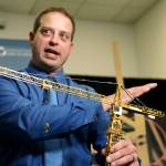 Brian Haight, crane program manager for Washington states Department of Labor and Industries, uses a model of a crane during a news conference Thursday in Tukwila to explain the collapse of a crane earlier in the year in Seattle that killed four people. (AP Photo/Elaine Thompson)