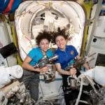 U.S. astronauts Jessica Meir (left) and Christina Koch pose for a photo in the International Space Station. On Friday, the two performed a spacewalk to replace a broken battery charger. (NASA via AP)
